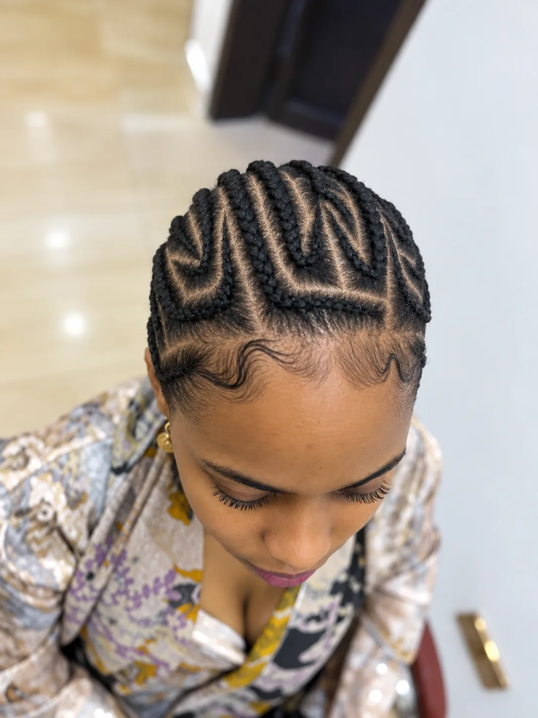 An updo set on natural 4C hair, photographed in the salon